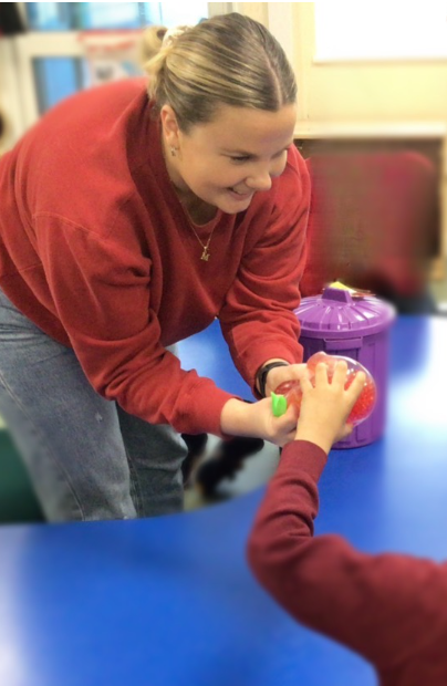 Megan working with a child on a sensory activity during a therapy session